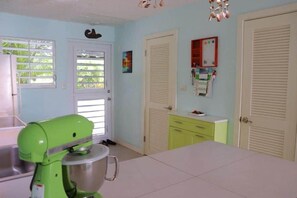 A kitchen with a green mixer, a sink, and a window with blinds. - La Dolce Villa in Jolly Harbour Antigua (Jolly Harbour)