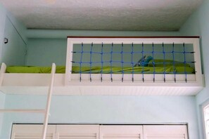 A bunk bed with a netted window, a ladder, and a door. - La Dolce Villa in Jolly Harbour Antigua (Jolly Harbour)