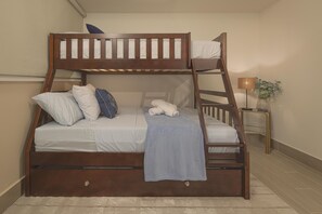 A bunk bed with a wooden frame, white bedding, and a blue blanket. - The Skyloft Oceanfront (Punta Chame)