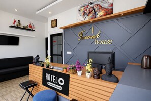 A hotel reception desk with a sign reading 'Hotel House' and a 'Hotel' sign below it. - Hotel O near Mall Boemi Kedaton 1 (Bandar Lampung)