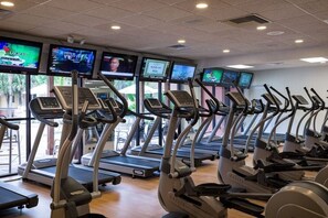 A gym with multiple treadmills and stationary bikes, equipped with digital screens displaying various content. - 2BR/2BA Westgate Villa Near Disney Resort Pools & Family Fun (Kissimmee)