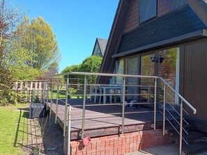 A residential property with a covered outdoor area, a staircase leading to a second floor, and a brick wall. - Gemutliche Unterkunft in Burhave (Butjadingen)
