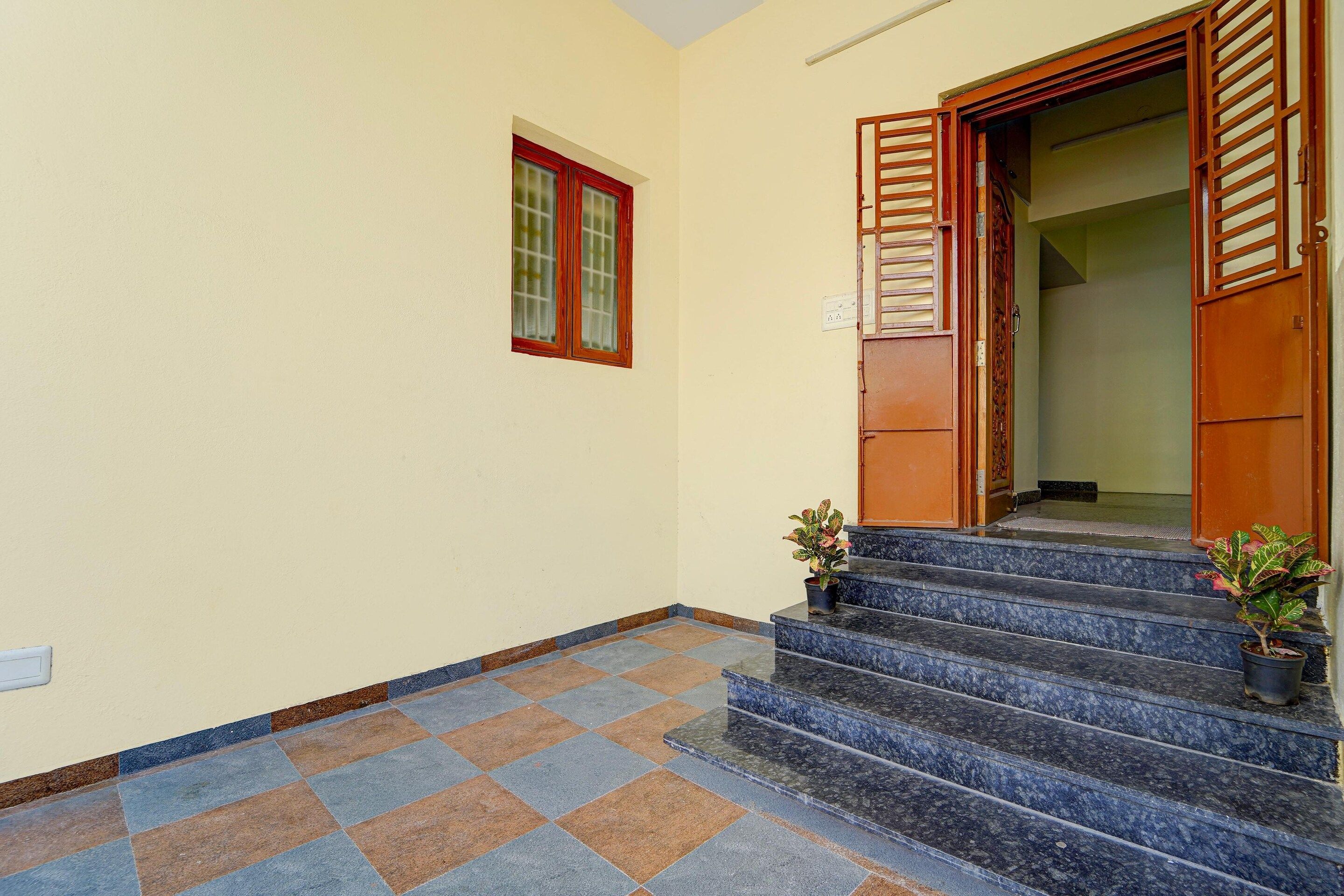 A staircase leading to a door with a window above it.