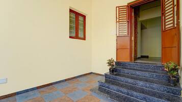 A staircase leading to a door with a window above it.