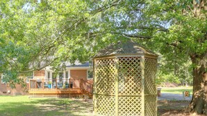 A gazebo with a lattice design, surrounded by grass and trees. - Back Deck, Grill, Yard! New Bern Family Home (New Bern)