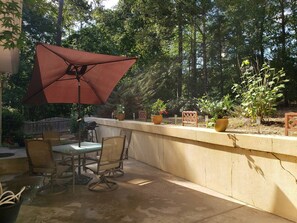 An outdoor patio with a table and chairs, a barbecue grill, and potted plants. - Right at Lake Tobesofkee & 10 miles from downtown! (Macon)