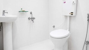A modern bathroom with a toilet, bidet, and sink.