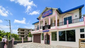 A two-story building with a sign for 'The Golden Stone' and a 'Collection & Spa Service' sign.