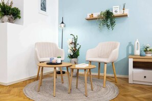 A room with two chairs, a small table, a lamp, and decorative plants. - Large Central Apt | Game Room • Xbox Pass • Fun (Praha 2)
