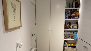 A narrow hallway with a radiator, a framed picture on the wall, and a white wardrobe with a closed door. - Cottage on a golf course (ideal for golf getaways). (Roldan, Torre Pacheco)
