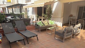 An outdoor patio area with lounge chairs, a sofa, and a small table. - Cottage on a golf course (ideal for golf getaways). (Roldan, Torre Pacheco)