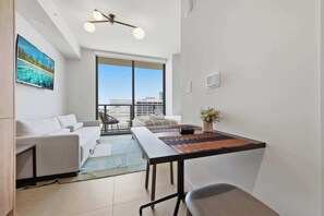 A modern living room with a sofa, a coffee table, and a TV. - The Crosby Balcony Studio Miami Worldcenter (Miami)