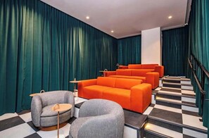 A hotel lobby with a checkered floor, a staircase, and a seating area with orange and grey furniture. - The Crosby Balcony Studio Miami Worldcenter (Miami)