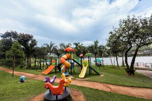 A playground with slides and a merry-go-round. - The Green Resort (55VH+7R6, Kigali,)