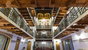A spacious interior with a central water feature, wooden beams, and ornate balconies. - Authentic and Traditional Bukhara designed hotel (Bukhara)