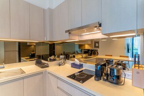 A modern kitchen with a large island, stainless steel appliances, and ample counter space. - Cassia Residences Spacious 2BR with Lagoon View (Choeng Thale (Thalang District))