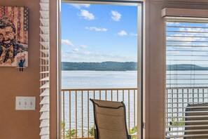 A room with a view of a body of water, a chair, and a painting on the wall. - Yakov's Hideaway - Lakefront (Hollister)