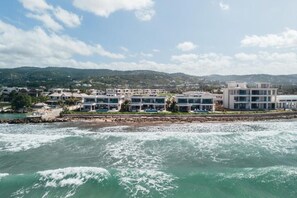 A coastal hotel with multiple buildings, a rocky shoreline, and a view of the sea. - Ocean View | 5BR Staffed Resort Villa by Bocobay (St. Ann’s Bay)