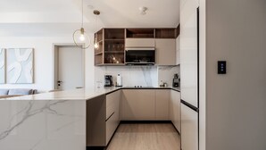 A modern kitchen with a marble countertop, built-in appliances, and a wooden ceiling. - w Elegant 2BR w Balcony AC in San Francisco (Panama City)