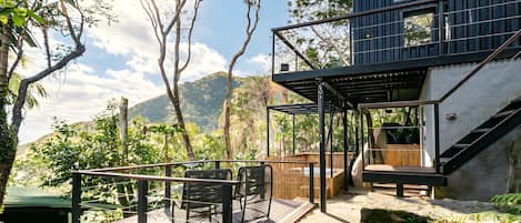 A modern outdoor deck with a view of a mountainous landscape.