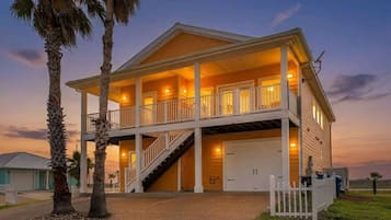 A two-story house with a balcony, a staircase, and a garage.