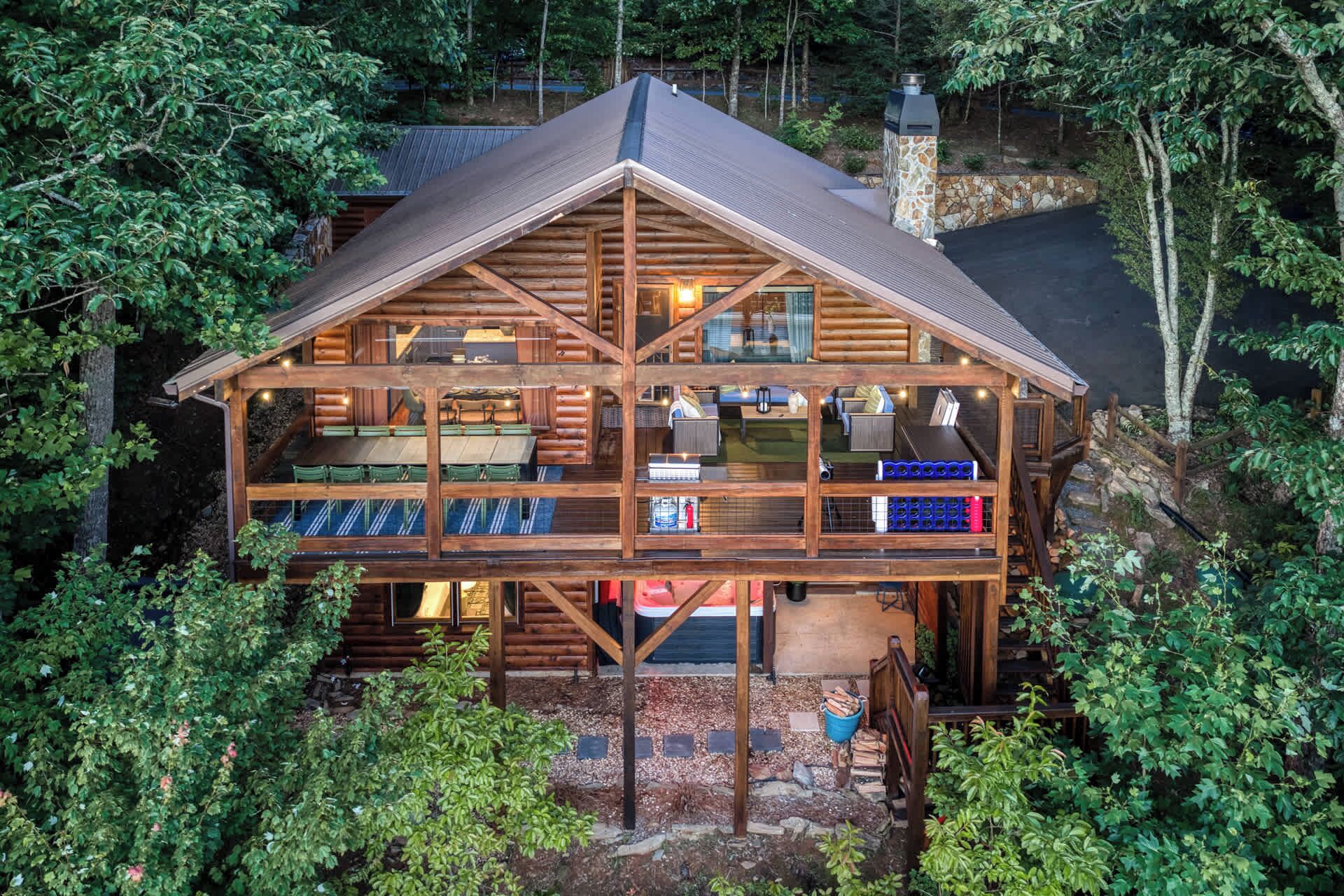 A log cabin with a central living area, a dining area, and a separate kitchen.