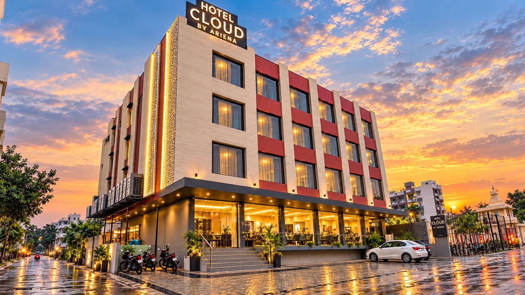 A hotel with a modern facade, multiple floors, and a prominent entrance with outdoor seating.