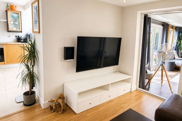 Relax and unwind with your favorite shows in a bright, modern living room designed for effortless indoor lounging.