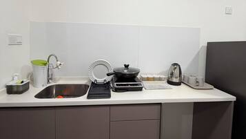 Fridge, electric kettle, cookware/dishes/utensils, dining table