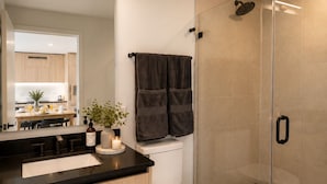 A modern bathroom with a toilet, sink, and shower area. - Modern 1BR Stay Near Brickell & Downtown Miami (Miami)