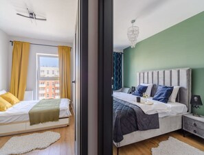 A bedroom with a bed, a nightstand, a lamp, and a window with curtains. - Quiet City Apartment in Lodz for 6 (Łódź)