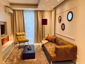 A modern living room with a sofa, armchair, and a coffee table. - Central Warsaw Home With Pool (Warsaw)