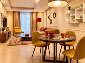 A modern living room with a sofa, a coffee table, and yellow chairs. - Central Warsaw Home With Pool (Warsaw)