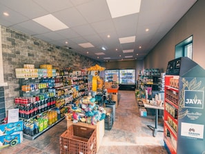 A grocery store interior with shelves stocked with beverages, snacks, and a refrigerated section. - Charming Chalet Near Efteling (Kaatsheuvel)