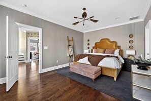 A bedroom with a wooden bed, a bench, a ladder, and a ceiling fan. - Uptown Charlotte Luxury 4 bedroom Townhouse walkable to everything (Charlotte)