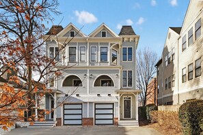 A two-story residential building with a symmetrical facade, a central entrance, and a garage. - Uptown Charlotte Luxury 4 bedroom Townhouse walkable to everything (Charlotte)