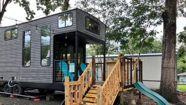 A mobile home with a deck and a slide. - Beautiful 3-bedroom recreational vehicle with water view in Bronson (Bronson)