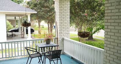 Porch swing, 1920s home, walk to live music