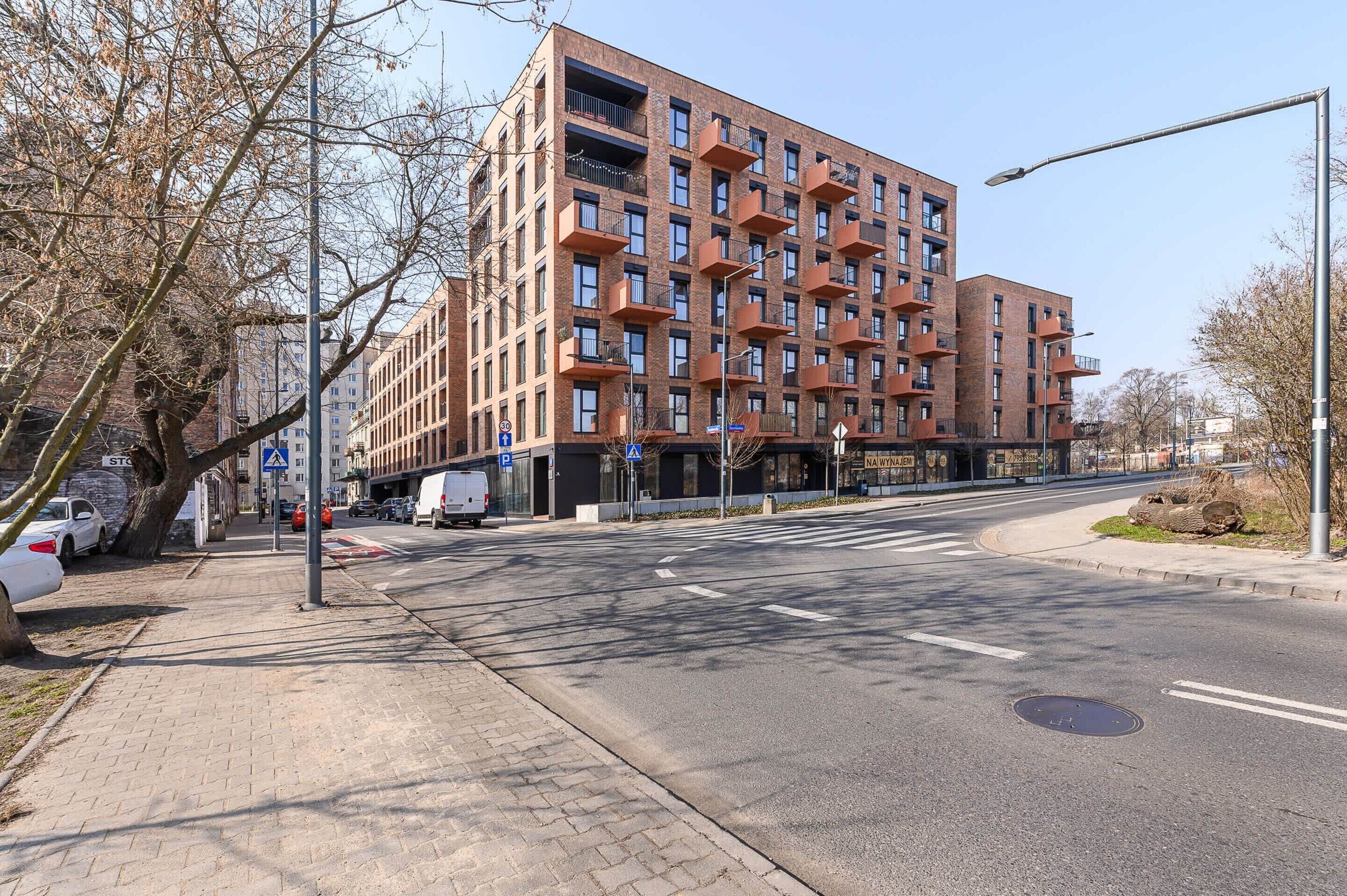 A multi-story building with a modern architectural design, featuring a uniform facade and balconies.