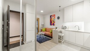 A modern apartment with a kitchenette, a dining area, and a living space. - City Apartment With Balcony (Warsaw)