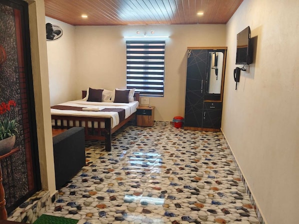 Un dormitorio con cama, mesita de noche y ventana con persianas.