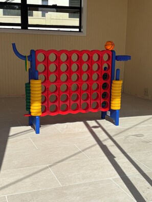 A red and blue play structure with a basketball hoop. - Sunny Cove Retreat: Walk to Beach, Dining & Marina (Deerfield Beach)