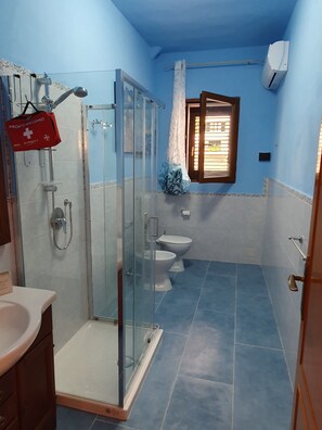 Een douche, een haardroger, een bidet, handdoeken