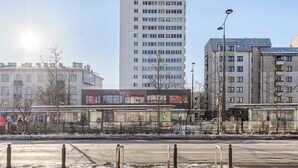 A multi-story building with a modern architectural style, featuring a series of windows and balconies. - Family Stay in Warsaw (Warsaw)