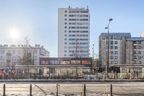 A multi-story building with a modern architectural style, featuring a series of windows and balconies. - Family Stay in Warsaw (Warsaw)