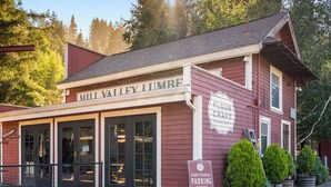 A red building with a sign reading 'Mill Valley Limbe' and another sign for 'Flour Craft Bakery & Cafe'.