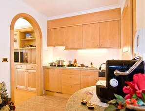A kitchen with wooden cabinets, a microwave, and a sink. - Residence Ciastel (Oltretorrente)