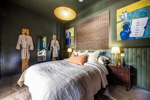 A modern bedroom with a large bed, bedside lamps, and artwork on the walls. - Luxury Converted Stable Cottage | Lake District | EV Charger & Private Patio (Carnforth)