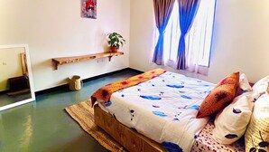 A bedroom with a bed, pillows, a bedside table, a plant, and a window with curtains. - Ngorongoro Haven & Safari Stride (Karatu)