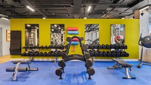 A gym with weightlifting equipment, mirrors, and a blue rubber floor. - Modern Tempe 1BR • AC + Pool + Gym • 5 Min to ASU (Tempe)